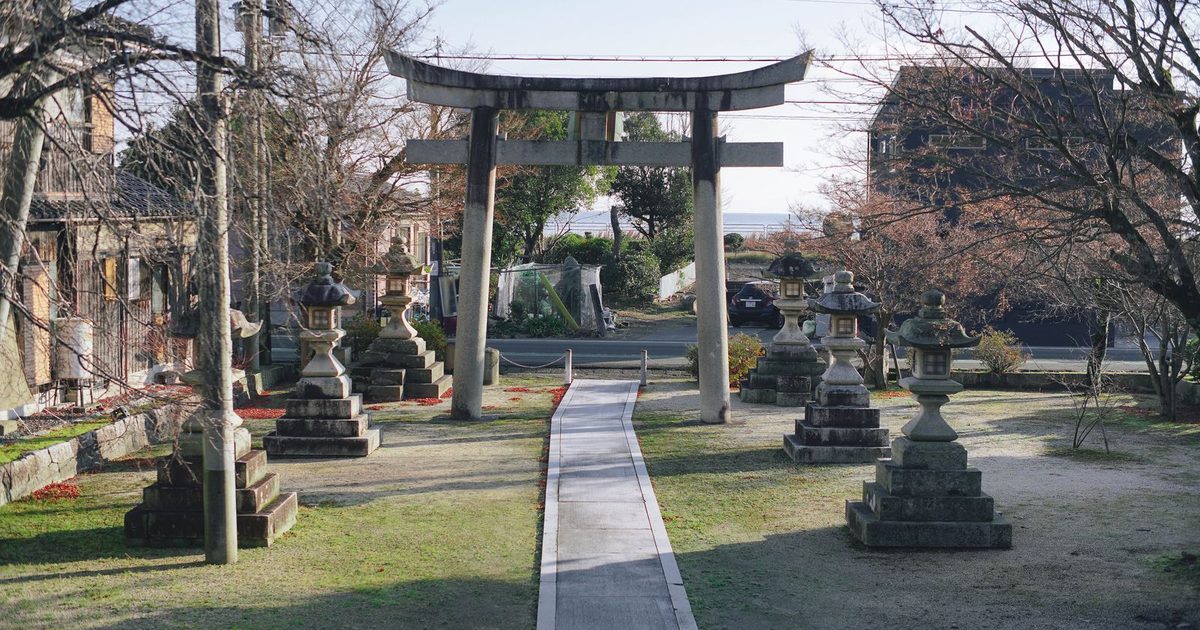 A torii gate and stone lanterns in Shiga, Japan